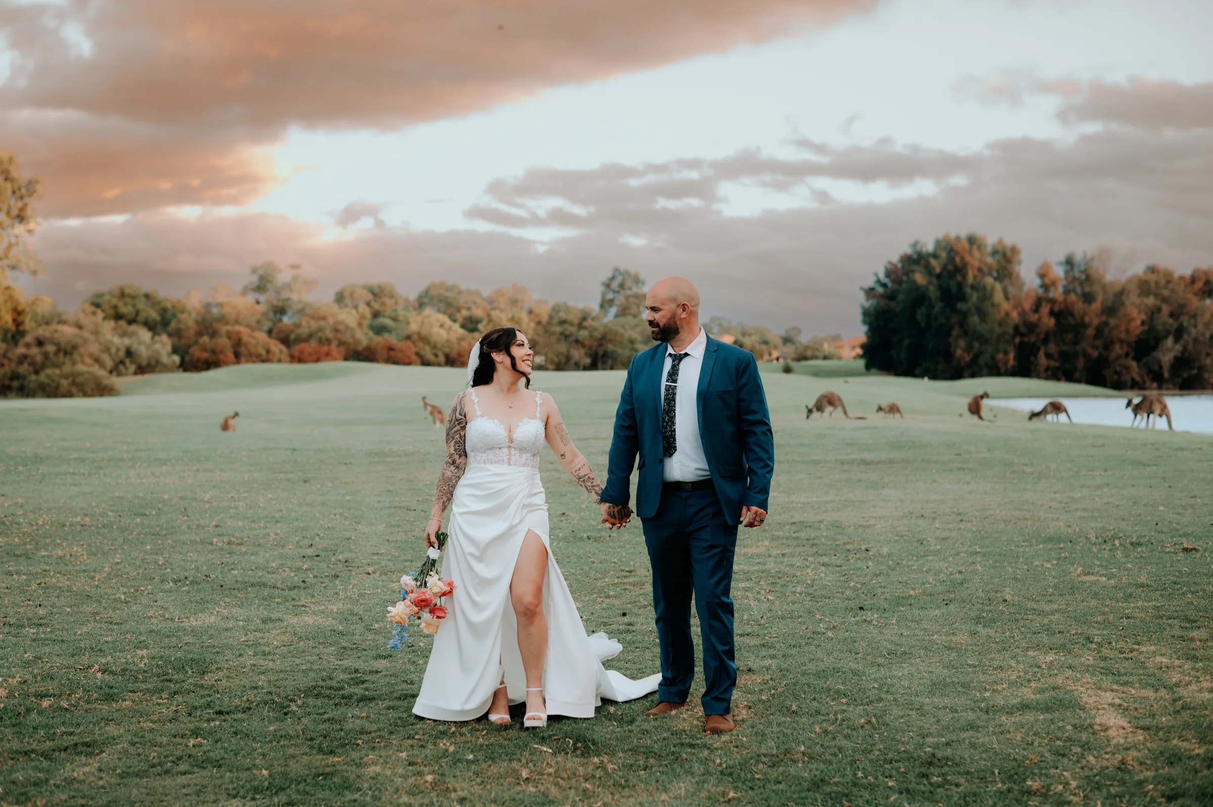 Kerry and Richard laughing together on the fairway at The Vines Resort at dusk, cinematic Perth wedding film