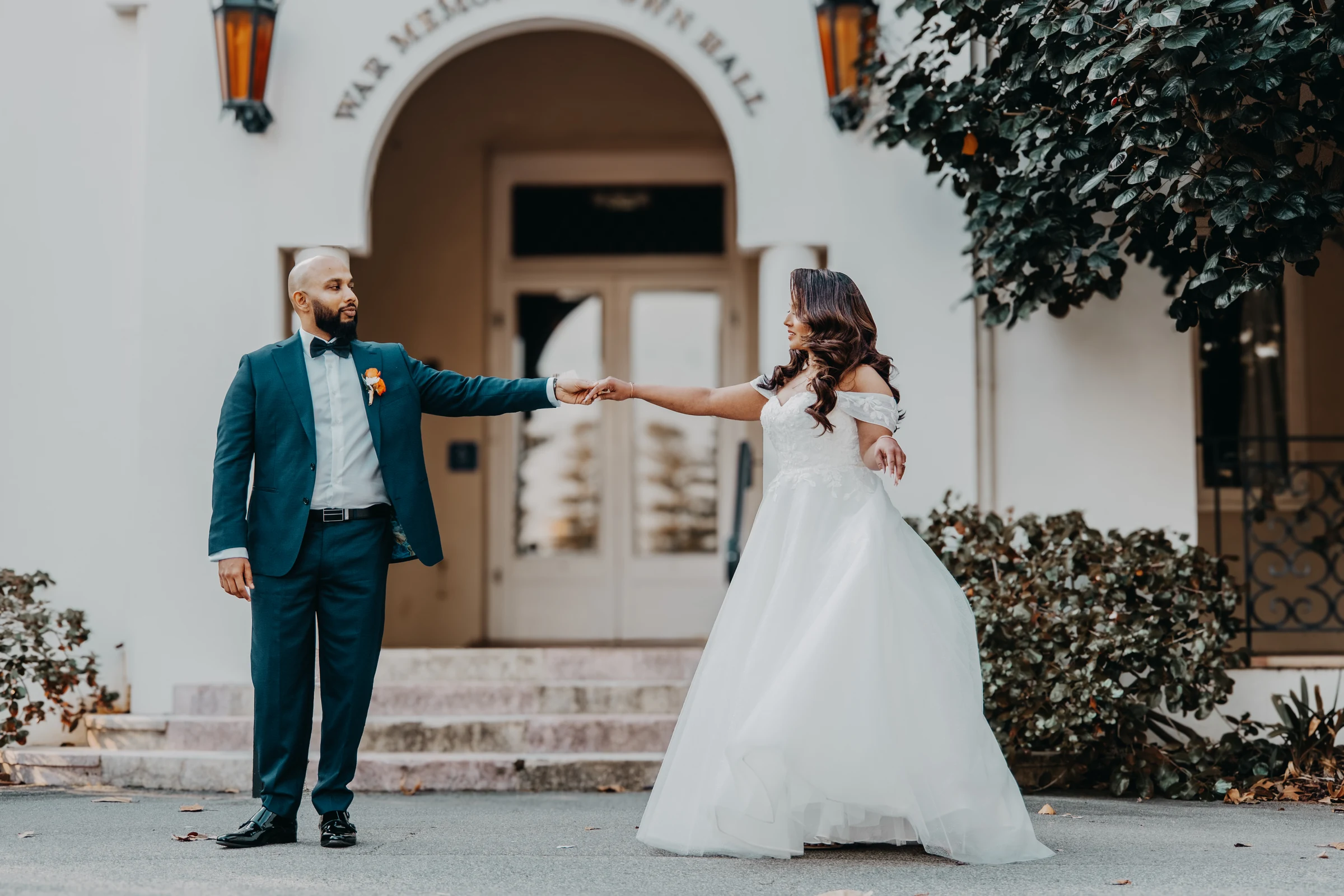Betsy and Jibin arriving at the Cottesloe Civic Centre courtyard, its Spanish Mission archways and fountain behind them