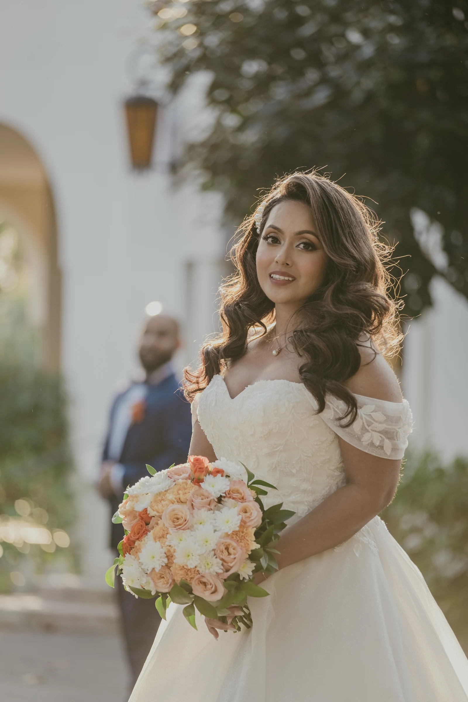 Betsy holding her bouquet in a soft portrait among the gardens of Cottesloe Civic Centre