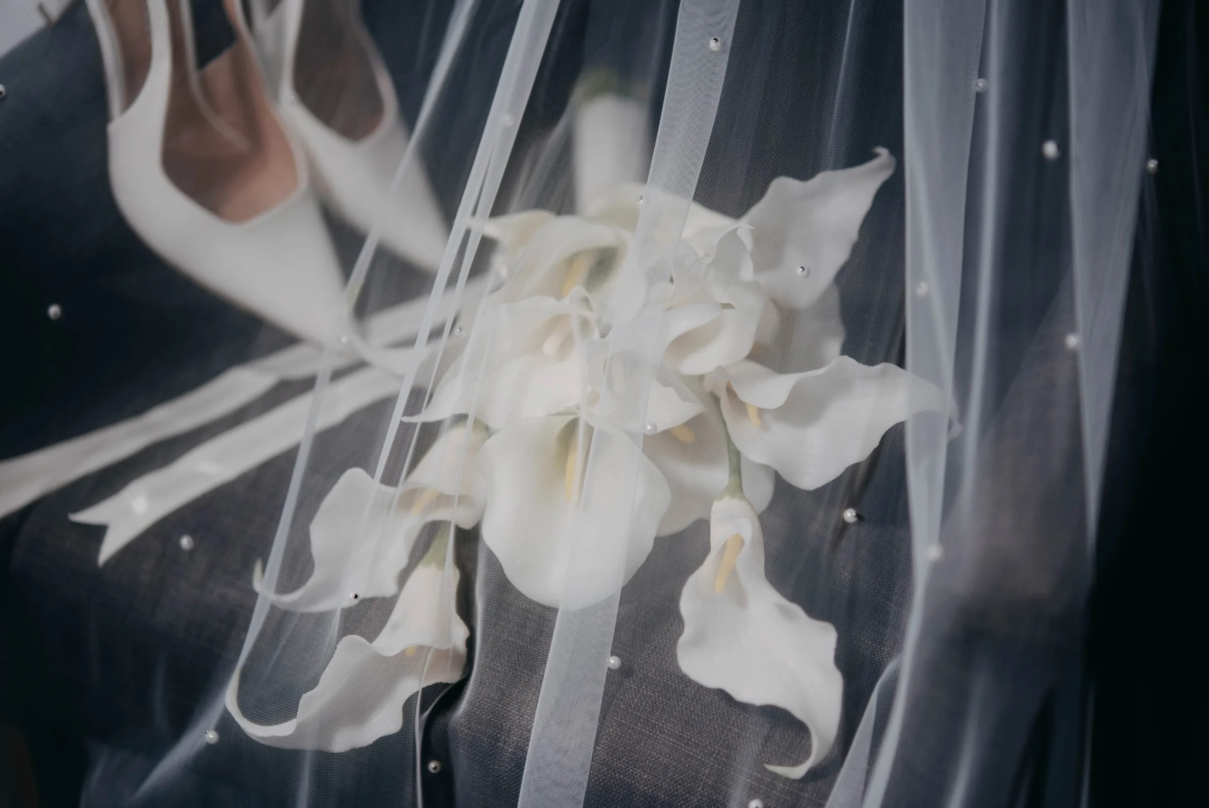 Macro detail of Kirra's veil and floral bouquet detail before her Vines Resort wedding