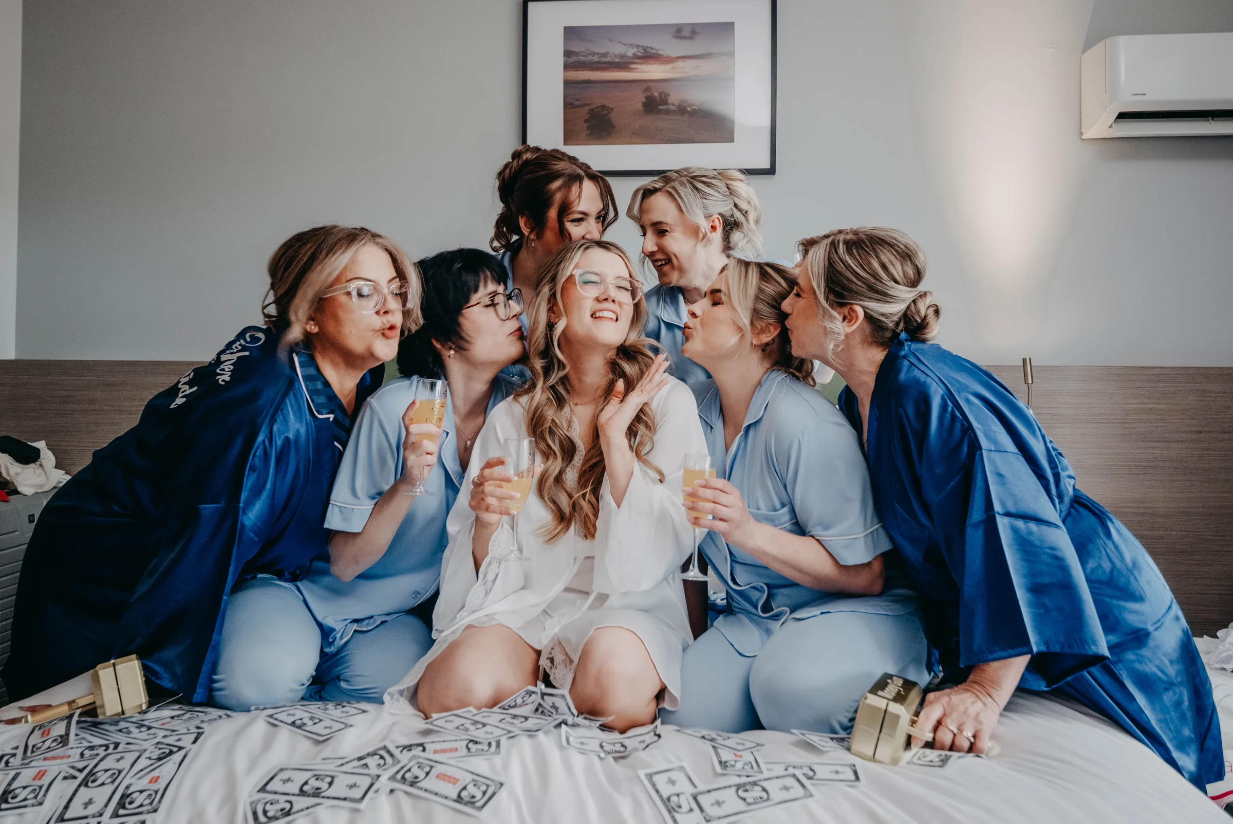 Kirra and her bridesmaids in matching robes toasting together before the wedding at The Vines Resort