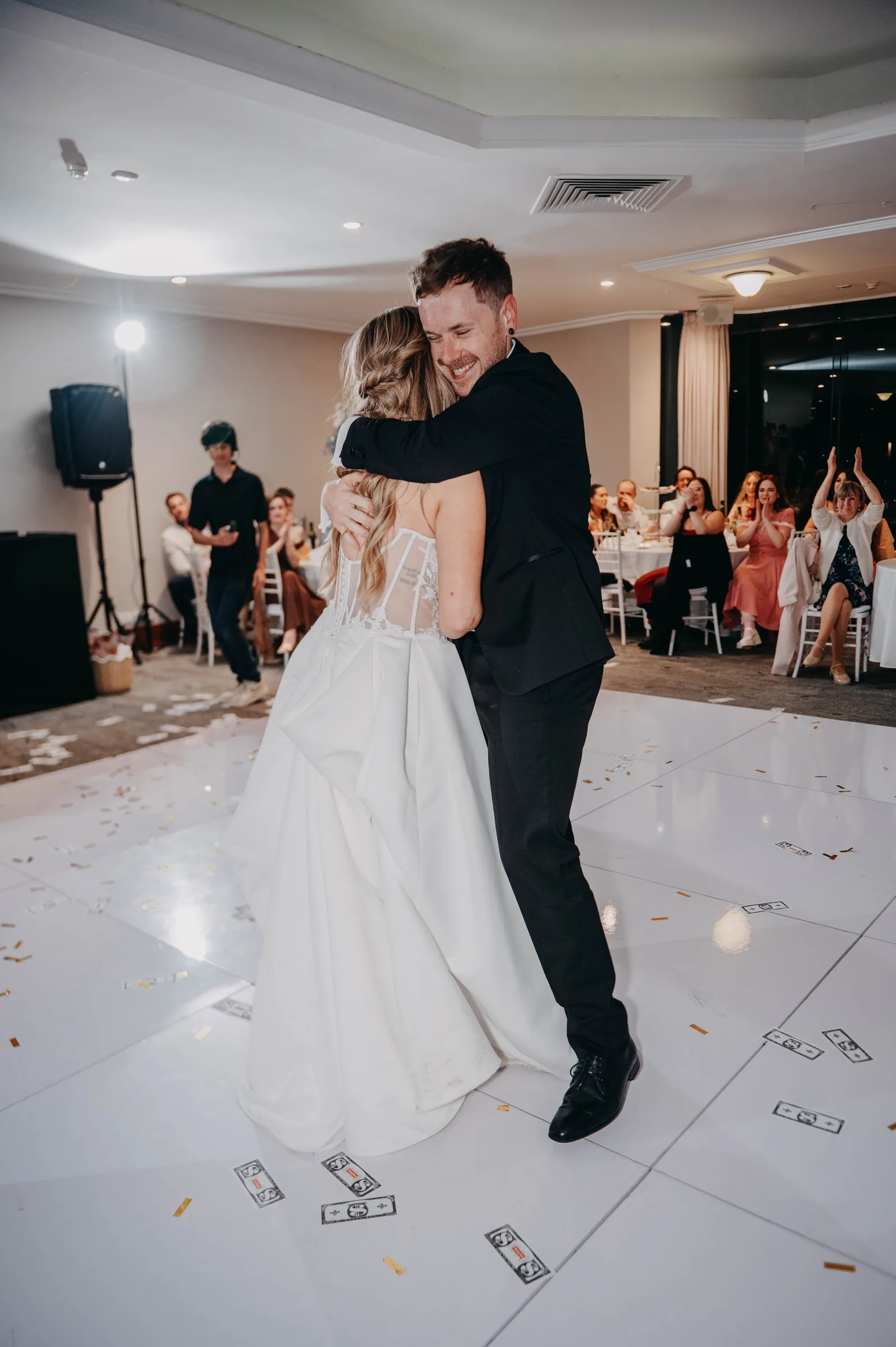 Kirra and Mitch embracing on the dance floor at the end of their Vines Resort wedding reception