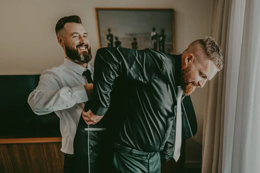 Zach putting on his shoes while getting ready for his Perth wedding day