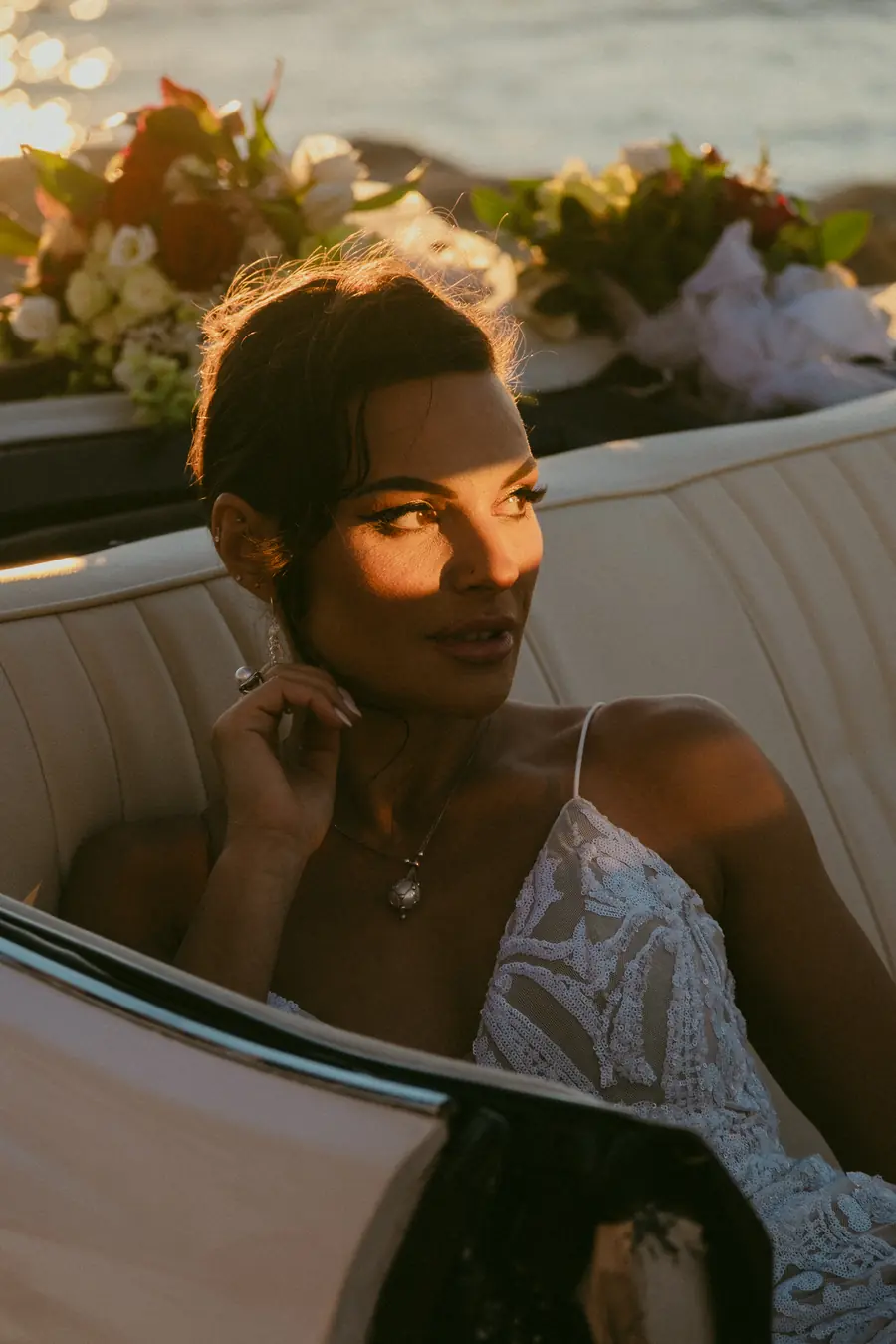 Close portrait of Katia in golden hour light beside her wedding bouquet, Coast Port Beach North Fremantle