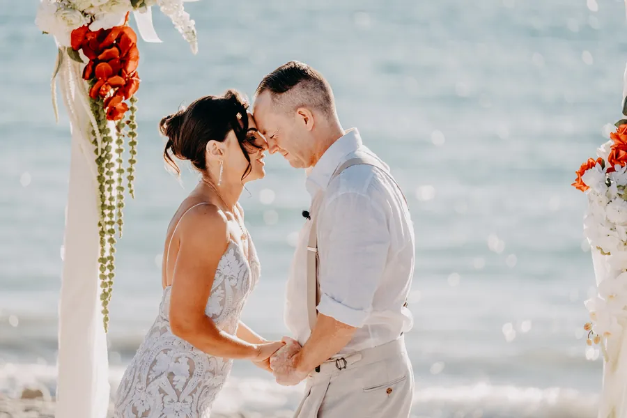 Sean reading his handwritten vows to Katia during their beach ceremony at Coast Port Beach