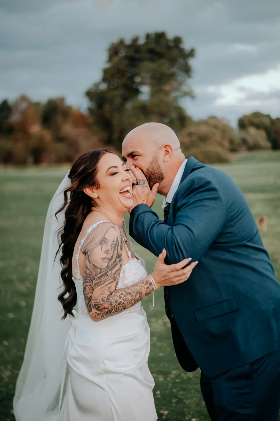 Groom whispering to laughing bride on the fairway at The Vines Resort, Perth wedding videographer