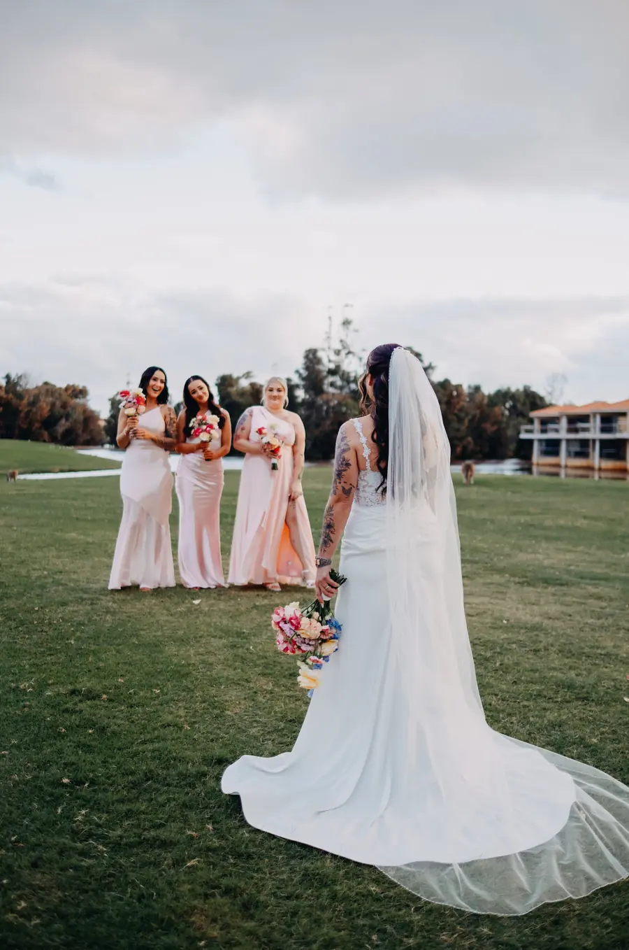 Kerry sharing an emotional first look with her bridesmaids on the lawn at The Vines Resort, Perth wedding photographer