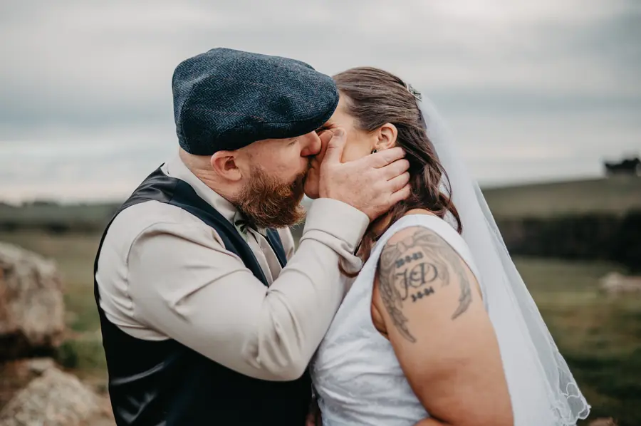 Ben kissing Liv on the cheek in the wheatbelt hills at Dalmore Farm
