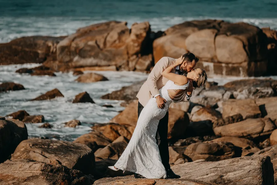 Luck dipping Victoria for a kiss among the boulders at Injidup Beach