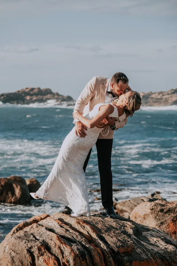 Luck dipping Victoria for a kiss on the rocks at Injidup Beach