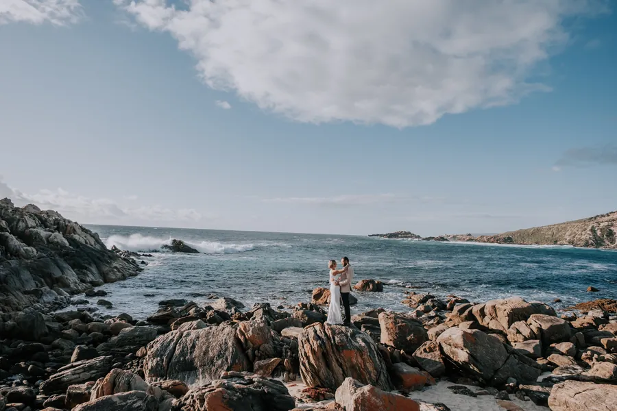 Victoria and Luck standing together on the rugged coastline at Injidup Beach