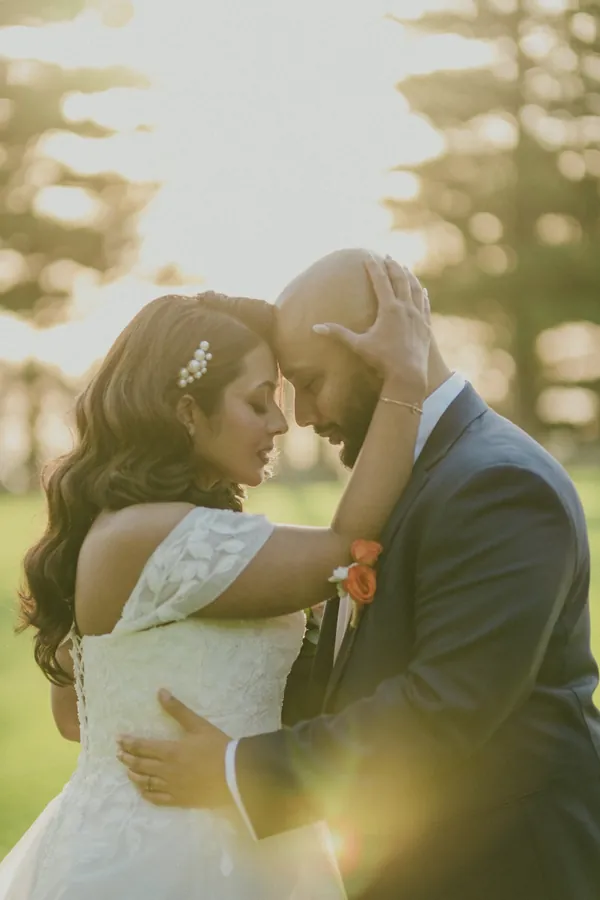 Betsy and Jibin forehead to forehead in the golden afternoon light at Cottesloe Civic Centre