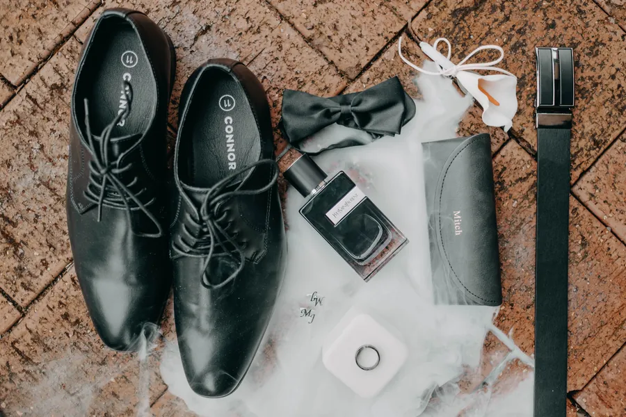 Flat-lay of Mitch's wedding shoes, watch and details before the ceremony at The Vines Resort