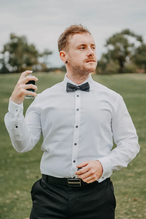 Mitch standing confidently in his shirt and bow tie before the ceremony at The Vines Resort