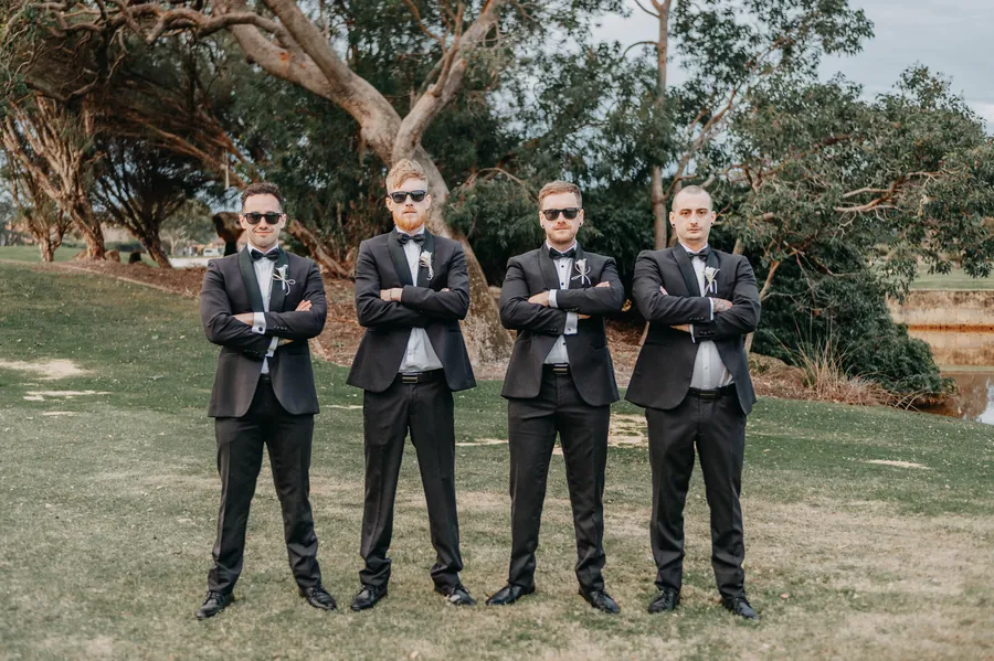 Mitch's groomsmen standing together with arms crossed on The Vines Resort fairway