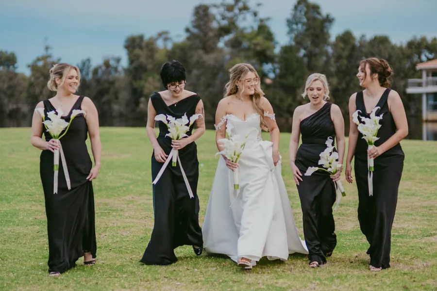 Kirra's bridesmaids gathered together with bouquets on The Vines Resort lawn